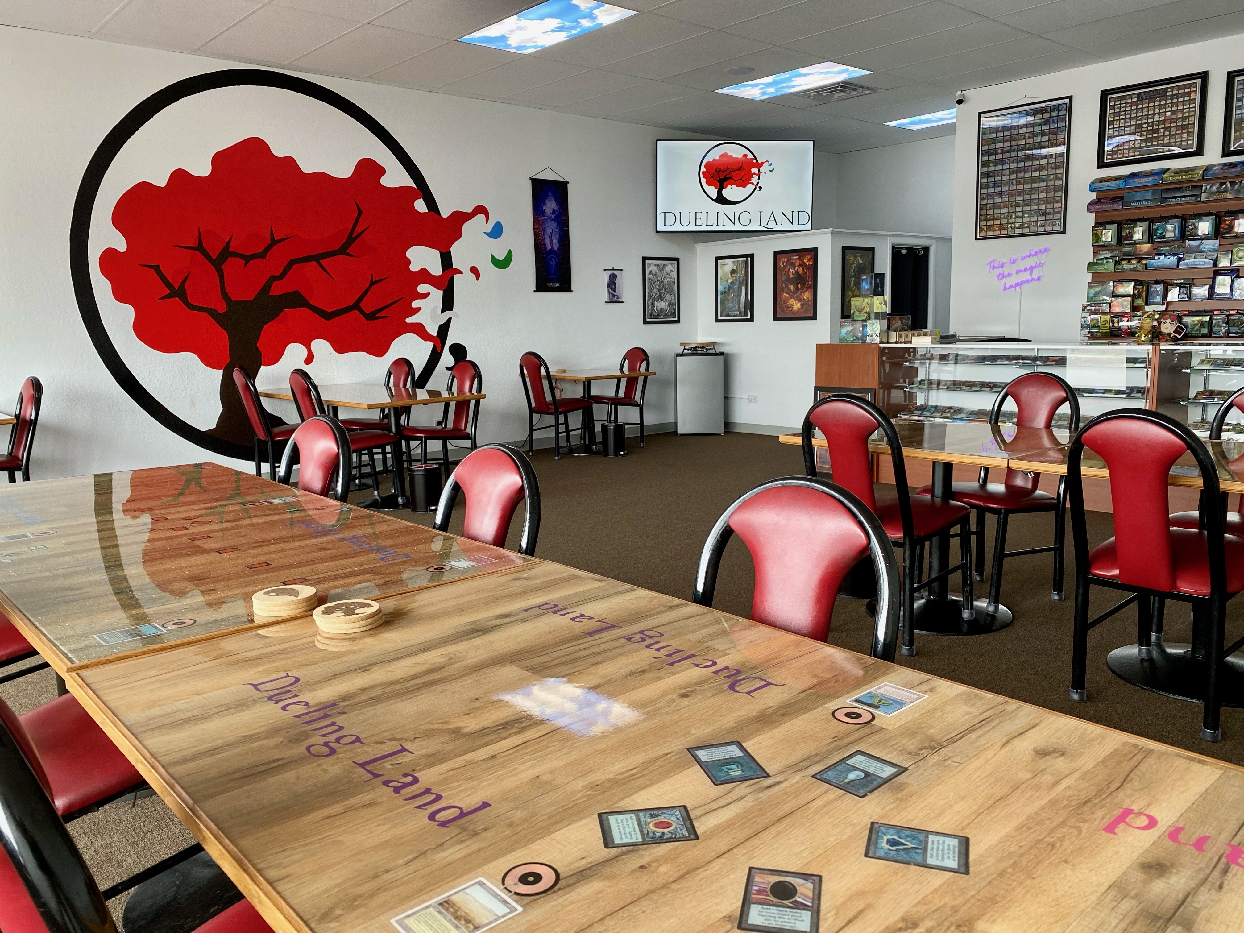 photo of store interior with a large tree with red leaves painted on one wall