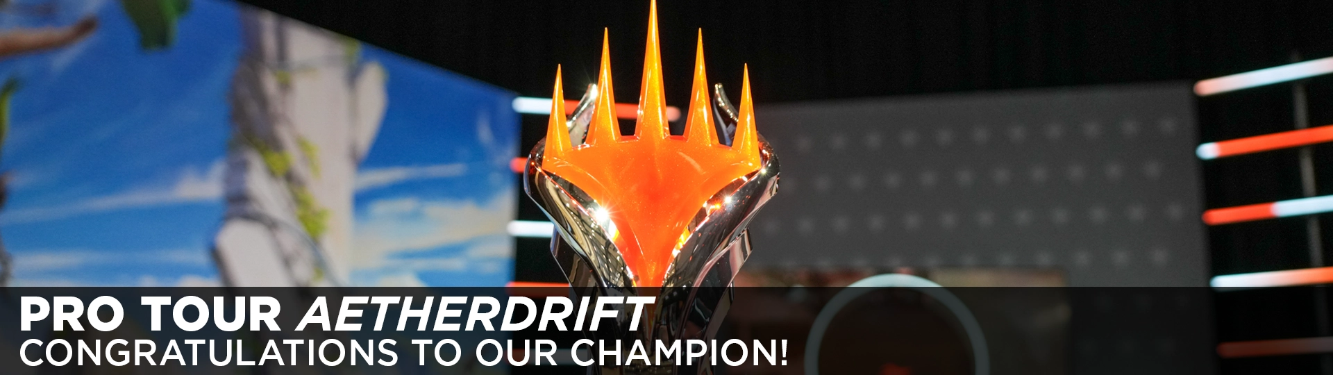 The Pro Tour Aetherdrift trophy on the main stage. Text: Pro Tour Aetherdrift, Congratulations to our champion!